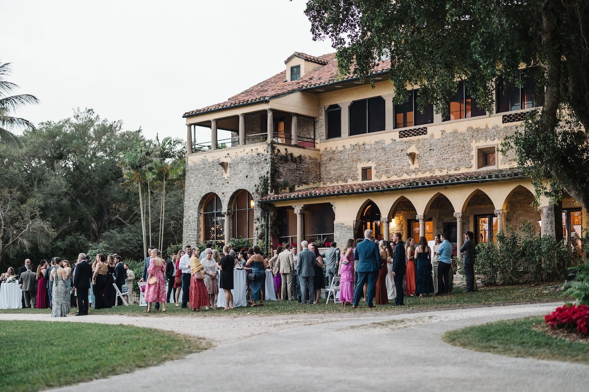 Historic wedding reception property in Miami, FL - Deering Estate hosting cocktail hour post ceremony on lawn in front of Stone House Museum